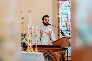 Father Timothy Furlow speaks from the ambo at St. Patrick’s Church in Portland, Oregon.