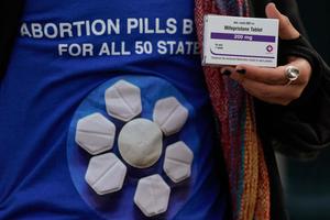 A pro-abortion rights activist holds a box of mifepristone during a rally in front of the Supreme Court on March 26, 2024, in Washington, DC. In both 2012 and 2018, Delgado co-authored a case series studying Abortion Pill Reversal, which New York Attorney General James takes direct aim at in her lawsuit against 11 pro-life pregnancy resource centers. 