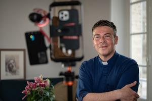 Father Matthieu Jasseron, priest of Saint Jean-Baptiste de Joigny parish, poses at his home in Joigny, central France, on Feb. 24, 2023. 