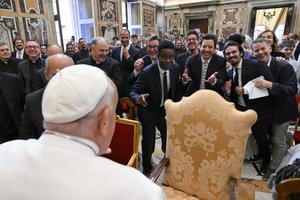 A group of comedians and humorists, including Chris Rock and Jimmy Fallon (center), share a lighthearted exchange with Pope Francis during a gathering with the pope in the Apostolic Palace at the Vatican on June 14, 2024.
