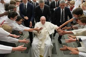 Pope Francis greets altar servers from France.