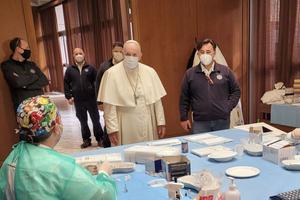 Pope Francis greets medical workers administering the vaccine against COVID-19 April 2, 2021.
