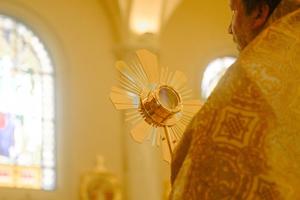 Father Mark Mary, of the Franciscan Missionaries of the Eternal Word, holds the Blessed Sacrament as the National Eucharistic Pilgrimage visits the Shrine of the Blessed Sacrament on June 20.