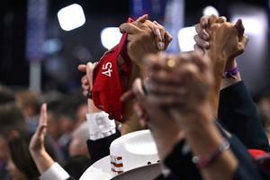 Delegates hold up their hands in prayer during the last day of the 2024 Republican National Convention at the Fiserv Forum in Milwaukee, Wisconsin, on July 18, 2024. 
