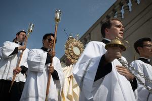 Bishop Andrew Cozzens of Crookston. Minnesota, carries the Blessed Sacrament down the steps of the Indiana War Memorial in Indianapolis on July 20.