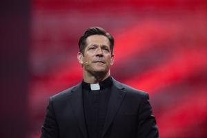 Father Mike Schmitz on stage at the National Eucharistic Congress in Indianapolis, Indiana.
