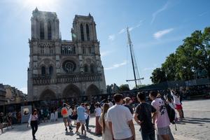 The main facade of Notre Dame de Paris Cathedral in Paris on July 28: The two towers of the cathedral are seen from the square full of tourists. 