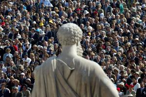 Pilgrims stand in front of a statue of St. Peter in St. Peter’s Square as Pope St. John Paul II offers the canonization Mass for Opus Dei founder St. Josemaria Escriva de Balaguer, Oct. 6, 2002. An estimated 250,000 pilgrims from around the world attended the ceremony.