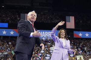 US Vice President and Democratic presidential candidate Kamala Harris (R) and Minnesota Governor and vice presidential candidate Tim Walz gesture during a campaign rally at the Thomas and Mack Center, University of Nevada in Las Vegas, Nevada, on August 10, 2024.