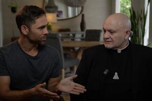 Ryan Bethea (left) and Father Carlos Martins (right), co-hosts of “The Exorcist Files” podcast.