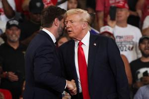 Former President and 2024 Republican presidential candidate Donald Trump (R) shakes hands with US Senator and 2024 Republican vice presidential candidate J.D. Vance as he arrives to speak at a campaign rally at the Georgia State University Convocation Center in Atlanta, Georgia, on August 3, 2024. 