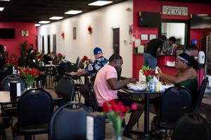 Haitians sit down to eat their meal at a Haitian restaurant in Springfield, Ohio, on September 12, 2024. 