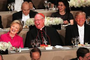 Cardinal Timothy Dolan sits between Hillary Clinton and Donald Trump as they attend the annual Alfred E. Smith Memorial Foundation Dinner at the Waldorf Astoria on Oct. 20, 2016, in New York City.  