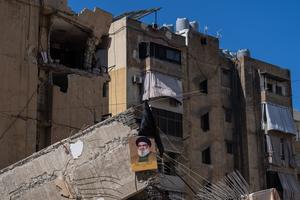A picture of former Hezbollah leader Hassan Nasrallah is displayed on the ruins of a building that was destroyed by an Israeli airstrike in the Hezbollah stronghold of Dahieh on Oct. 2 in Beirut.