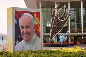 A smiling Pope Francis is depicted on a sign outside the APEC Haus in Port Moresby, Papua New Guinea, on the occasion of the pontiff's visit, Sept. 7, 2024.