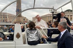 Pope Francis puts on the zucchetto from Daniel Allan on Oct. 23.