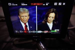 Republican presidential nominee, former U.S. President Donald Trump and Democratic presidential nominee, U.S. Vice President Kamala Harris are seen on a screen as they debate for the first time during the presidential election campaign at The National Constitution Center on September 10, 2024 in Philadelphia, Pennsylvania. 