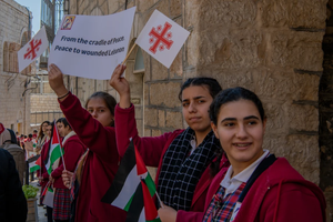 Children welcome the custos of the Holy Land, Father Francesco Patton, upon his entrance into Bethlehem on Nov. 30, 2024, for the beginning of Advent. The custos’ entry was festive, but at the same time, it was impossible to ignore the echoes of war. The children were holding signs with messages of peace and solidarity for those suffering due to the war.