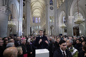 Attendees including workers of reconstruction of Notre-Dame de Paris Cathedral gather during a speech by French President Emmanuel Macron (center) in the nave of the cathedral in Paris on Nov. 29, 2024. 