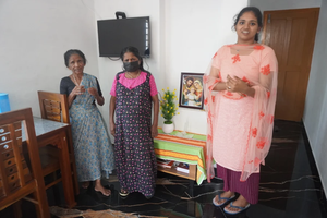 A family gathers in a prefabricated house donated by the Philokalia Foundation in Kerala state in India.
