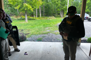 An FBI agent stands outside the Houck residence in Kintnersville, Pennsylvania, on Sept. 23, 2022. Mark Houck was arrested that day and charged with assaulting a Planned Parenthood escort outside an Philadelphia abortion clinic on Oct. 13, 2021.