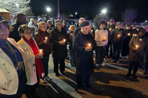 Participants pray during a peace walk in Baltimore promoted by the Archdiocese of Baltimore,  Monday, Dec. 30, 2024.