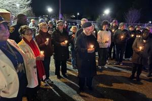 Participants pray during a peace walk in Baltimore promoted by the Archdiocese of Baltimore, Monday, Dec. 30, 2024. 
