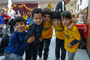 Children of Afghan immigrants to St. Louis play during a holiday party on Dec. 9, 2023.