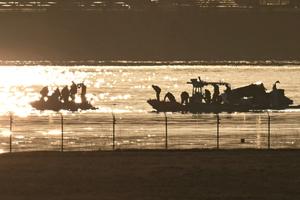Rescue crews search the wreckage of American Airlines Flight 5342 on Thursday in the Potomac River near Washington, D.C.