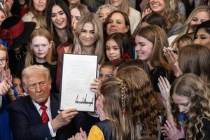 U.S. President Donald Trump holds up the ‘Keeping Men Out of Women’s Sports’ executive order after signing it in the East Room of the White House in Washington on Feb. 5, 2025, in the presence of young women who play sports.