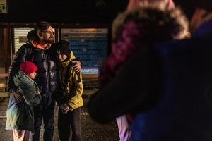 Sergiy, 36, stands with his nephews Zhasmin (10 ,at left) and Lev (13) after Ukrainian children crossed the border from Belarus to Ukraine, in the Volyn region, on Feb. 20, 2024, amid the Russian invasion of Ukraine. Eleven Ukrainian children crossed the border from Belarus to Ukraine that evening, in the return of some children taken to Russia and occupied territories. An estimated 20,000 children have been forced to Russia since the war erupted in February 2022. 