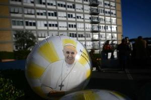 A balloon with an image of Pope Francis stands outside Gemelli Hospital in Rome, where Pope Francis is hospitalized with pneumonia. Pope Francis suffered two new breathing attacks on March 3, 2025, the Vatican said, as the 88-year-old pontiff struggles to recover from pneumonia.