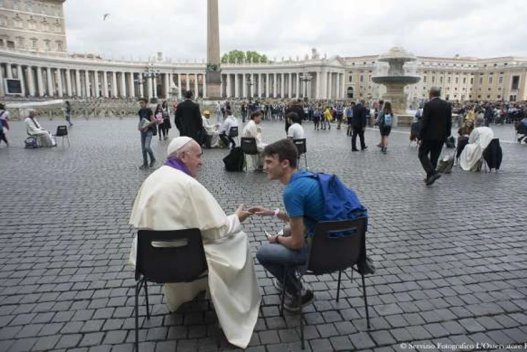Pope Francis hears confessions of teenagers in St. Peter's Square.