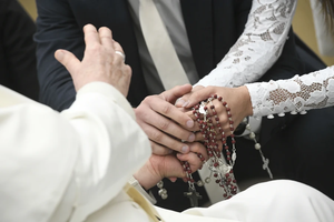 Pope Francis blesses a newly married couple during his general audience on Wednesday, Jan. 17, 2024, in the Paul VI Audience Hall at the Vatican.