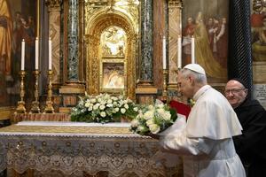 Pope Leo XIV brings flowers to the altar of the Sanctuary of the Madre del Buon Consiglio (Mother of Good Counsel) in Genazzano, near Rome, where he made a surprise visit two days after his election, Saturday, May 10, 2025. 