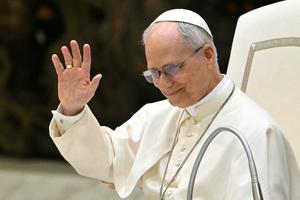 Pope Leo XIV waves as he leads an audience to representatives of the media, at Paul VI Hall in the Vatican, on May 12, 2025.     