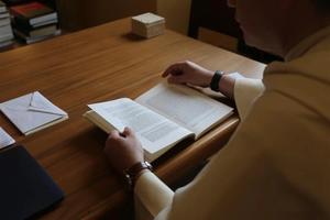 Dominican Father Thomas Joseph White reads the thesis of then-Father Robert Prevost, now Pope Leo XIV, which he wrote while a student at Rome’s Pontifical University of St. Thomas Aquinas in the early 1980s.