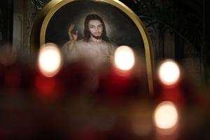 Candles glow by a Divine Mercy image at St. Patrick’s Cathedral on May 8, 2025, in New York City.  