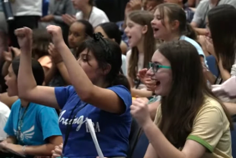 Young students cheer during an assembly at Bishop O’Connell High School in Arlington, Virginia, Saturday, May 10, 2025.