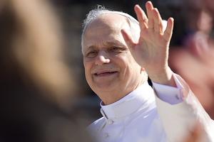 Pope Leo XIV waves to the faithful during a ride on his popemobile after the Inauguration Mass May 18, 2025.