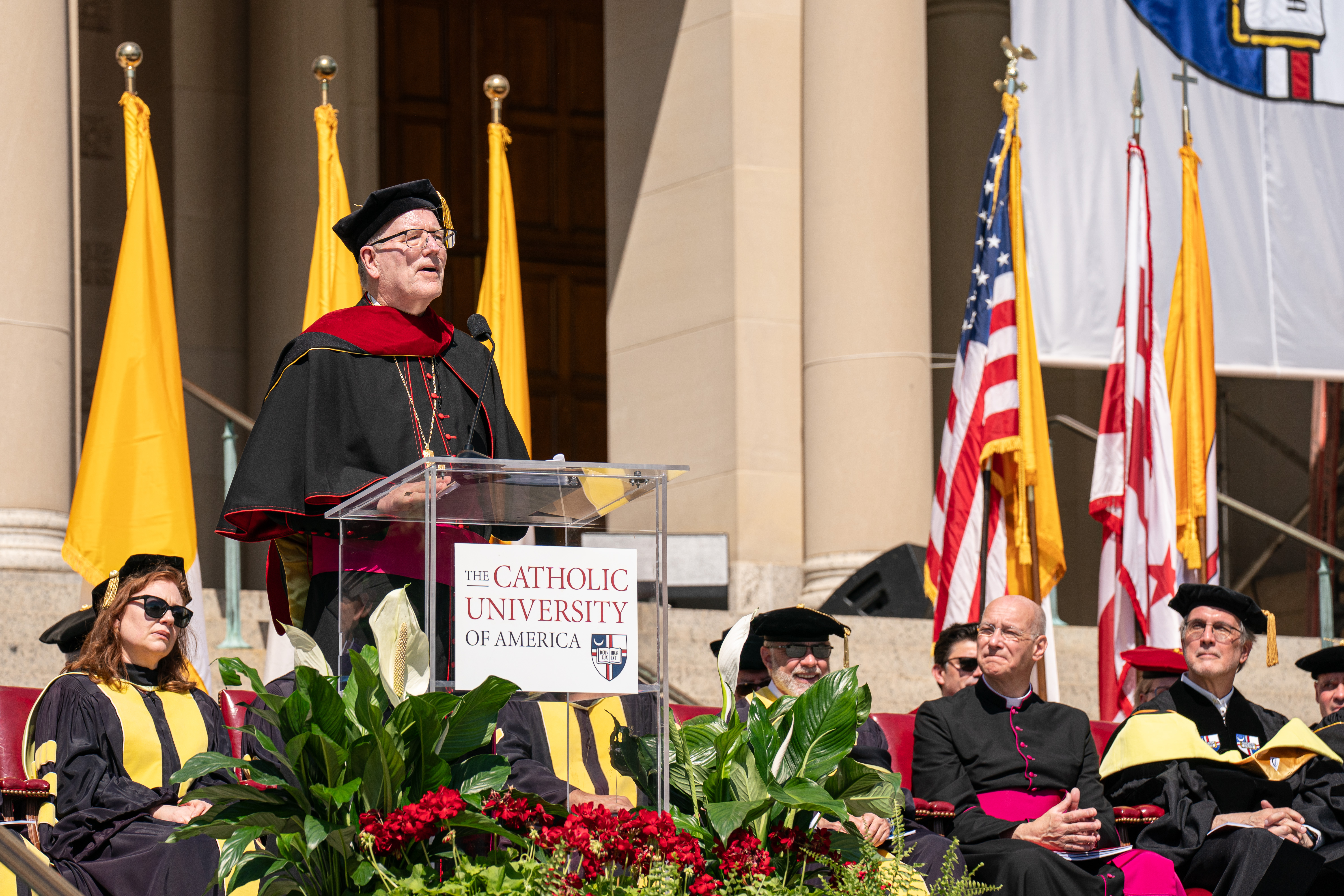 Bishop Robert Barron addresses graduates on a sunny day in Washington, D.C. 