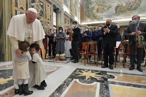 Little children hug Pope Francis as part of an audience with the Casa dello Spirito e delle Arti Foundation, in the Vatican’s Clementine Hall, on Feb. 4, 2022.