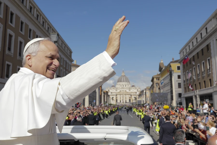 From the popemobile, Pope Leo XIV greets thousands of people lined up along Via della Conciliazione on the morning of his inaugural Mass, Sunday, May 18, 2025.