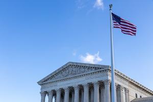An American flag flies next to the U.S. Supreme Court building.