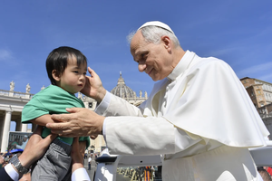 Pope Leo XIV blesses a small attendee at the general audience in St. Peter’s Square on Wednesday, June 4. 2025.
