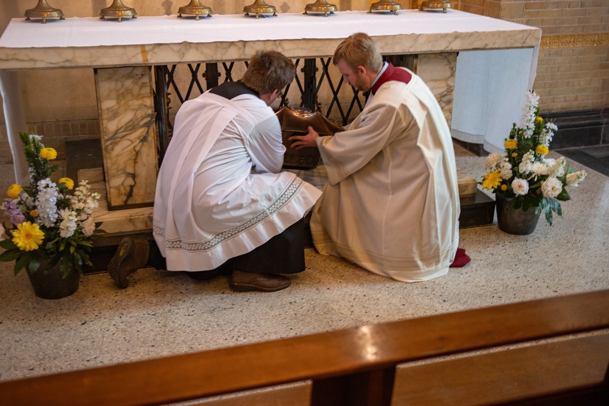 Relics being plaed beneath the altar. 