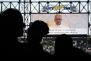 Pope Leo XIV addresses Catholic faithful on the scoreboard at Rate Field, home to the Chicago White Sox, during a celebration and Mass to honor his election as Pope on June 14, 2025, in Chicago. 
