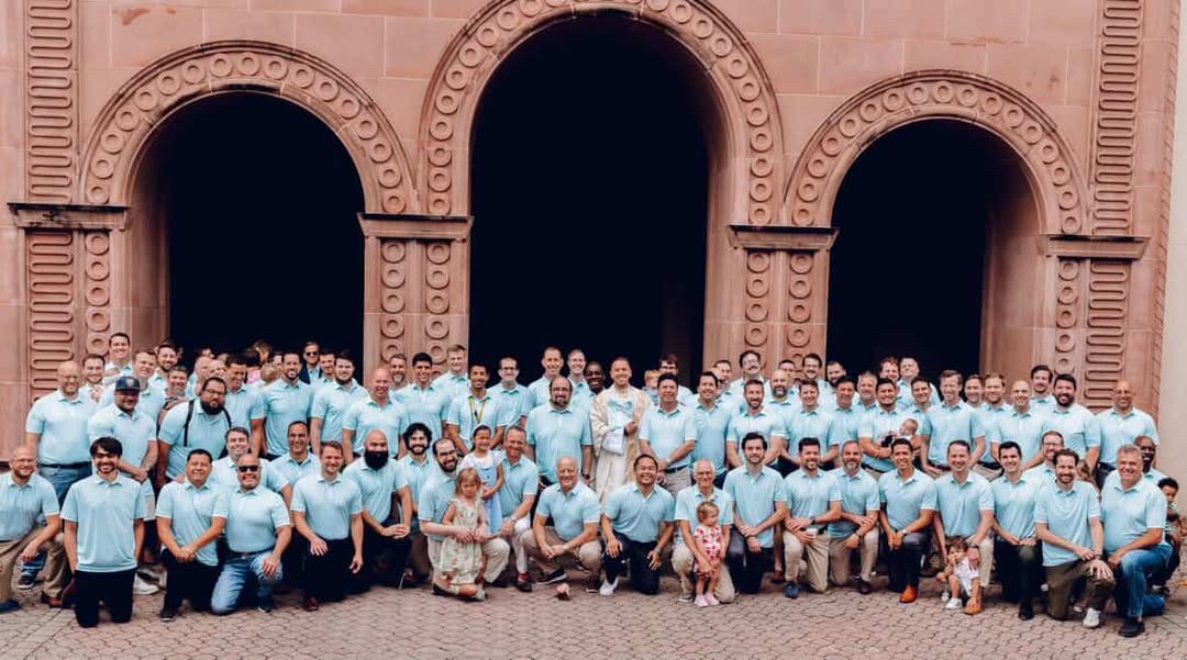 Dads gather to take a photo on Father's Day 2025 in matching polos.