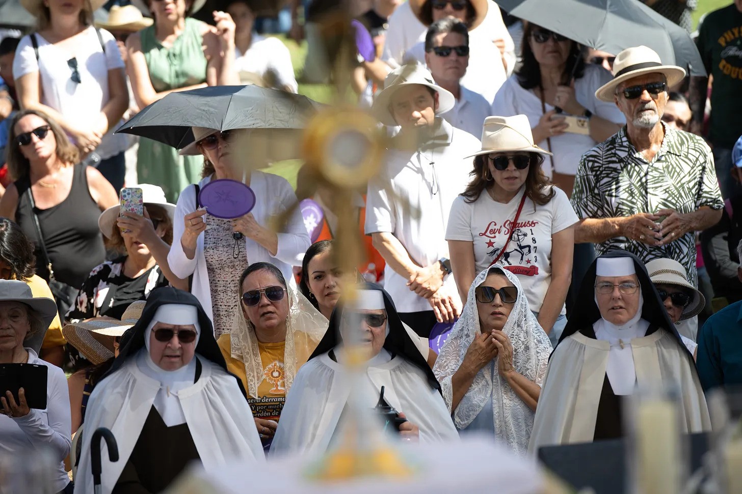 Religious sisters among the crowds waiting for Christ to pass in the Blessed Sacrament along the National Eucharistic Pilgrimage.