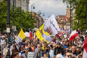 A giant flag depicting Pope St. John Paul II waves over heads of participants as thousands of people take part in the March of Life in Warsaw, on April 14, 2024. 